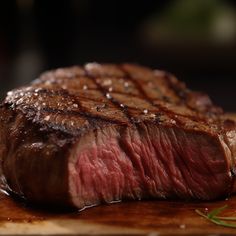 a piece of steak sitting on top of a wooden cutting board