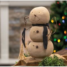 a snowman sitting on top of a wooden block