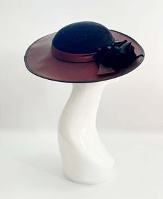 "Classic vintage hat. Perfect for Ascot, weddings, special occasions, very elegant. Comes with elastic to hold hat in place. Condition: vintage perfect Colour: black and dark burgundy Label: Made in England Material: polyester Size: M inner circumference aprox. 21.5-22 inches, circumference 44\"\" *Please note all hats come securely packed in a box *All our vintage items come in clean and best condition possible *Please note all hats come securely packed in a box *All our vintage items are top q Formal Wide Brim Felt Hat, Fitted Fedora With Curved Brim For Evening, Adjustable Wide Brim Felt Hat For Evening, Formal Fitted Cloche Felt Hat, Classic Wide Brim Hat For Evening, Fitted Wide Brim Hat For Vintage Events, Elegant Fedora Felt Hat For Party, Elegant Party Fedora Felt Hat, Classic Wide Brim Felt Hat For Party