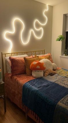 a bed room with a neatly made bed and a neon sign above the headboard