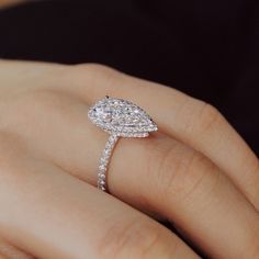 a woman's hand with a diamond ring on it