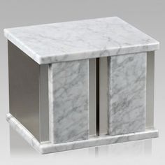 a white marble box with two doors on the front and one door open to reveal something