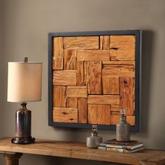 a wooden table with a lamp on top of it next to a framed wood paneled wall