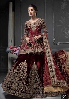 a woman in a red and gold wedding dress