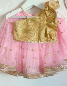 ✨ Whether it's for a wedding, party, or religious ceremony, this outfit is sure to make your child stand out and feel like a true princess. ✨ The Baby Pink Lehenga Set is a stunning ensemble for young girls that exudes elegance, grace, and charm. This outfit is perfect for those special occasions when you want your child to look their best and feel comfortable at the same time. The outfit consists of a gorgeous baby pink lehenga with intricate golden embroidery and a matching golden top that complements it perfectly. The lehenga is made with high-quality material that is soft, durable, and lightweight, ensuring that your child can wear it comfortably for hours on end.  ✨ The Toddler Lehenga Choli is perfect for a variety of occasions, from weddings and parties to religious ceremonies and f Festive Pink Lehenga With Ruffles, Pink Ruffled Choli For Navratri, Pink Ruffled Choli For Wedding, Pink Ruffled Lehenga For Diwali, Pink Ruffled Sets For Eid, Festive Pink Ruffled Choli, Party Lehenga With Ruffles For Navratri, Bollywood Style Ruffled Sets For Wedding, Bollywood Style Ruffled Wedding Sets