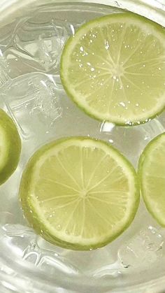 three slices of lime sitting on top of a glass plate