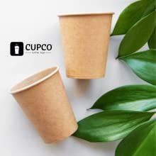 two coffee cups sitting next to each other on top of green leaves with the cupco logo above them