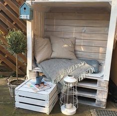 an outdoor bed made out of pallets and crates