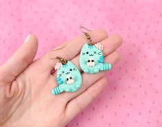 Hi CutiePie,  We're cute cat earrings. We're earrings created from polymer clay without using any molds and completely handmade. We can be a funny gift for people of all ages. We'll always cheers You up and will bring a smile on your face.Our dimensions are:Length 1" ( or 2.5 cm. )Width 0.8" ( or 2 cm. )But I can also be made as necklace, a brooch or a keychain.My dimensions as keychain:Length 1.2" ( or 3 cm. )Width 1" ( or 2.5 cm. )My dimensions as necklace:Length 1.2" ( or 3 cm. )Width 1" ( or Cute Handmade Cat Ears Jewelry, Kawaii Cat Ears Jewelry For Gift, Cute Cat Earrings, Zombie Earrings, Cute Cat Design Earrings As Gift, Cute Cat Design Earrings For Gift, Halloween Cat Clay Earrings, Cat Earing Clay, Adjustable Cute Cat Design Earrings