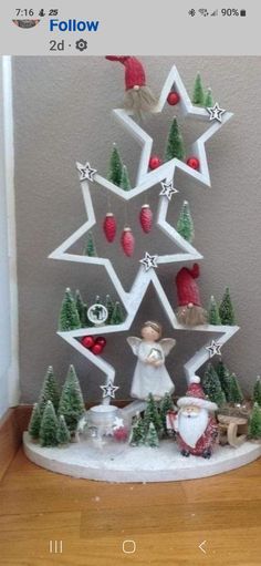 a christmas tree made out of paper with santa and other decorations on top of it