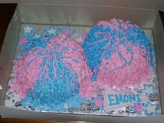 two pink and blue frosted cakes in a box with the word emont on it