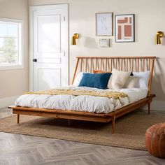 a bedroom with white walls and wood furniture