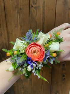 a woman's hand holding a bouquet of flowers