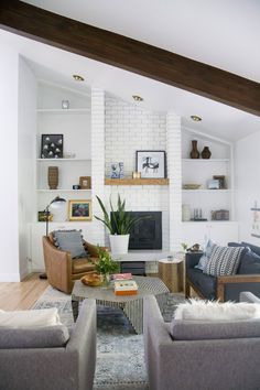 a living room filled with furniture and a fire place