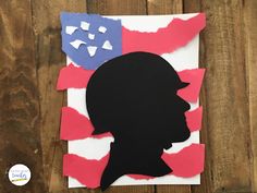 a paper cut out of the silhouette of a person with an american flag on it