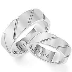 two white gold wedding rings with engraved names on each side and the words, diama