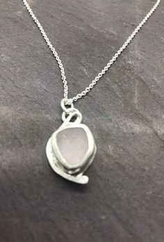 Individually handcrafted sterling silver pendant with a rare soft pink seaglass nugget collected in Kintyre on the west coast of Scotland.  The naturally tumbled sea glass sits within a fine silver bezel setting with free form textured knotted wire detail.   The pendant is suspended on a delicate sterling silver chain - please select your preferred length at checkout.  Makes an ideal gift for ladies or girls, wife or girlfriend - birthday, Christmas, anniversaries.  Other similar items available Silver Sea Glass Round Pendant Jewelry, Elegant Handmade Sea Glass Necklace, Wire Wrapped Silver Sea Glass Necklaces, Silver Sea Glass Necklace With Wire Wrapped Detail, Sea Glass Round Necklace As Gift, Wire Wrapped Silver Necklace With Sea Glass, Round Sea Glass Necklace As A Gift, Round Sea Glass Necklace For Gift, Round Sea Glass Jewelry Gift