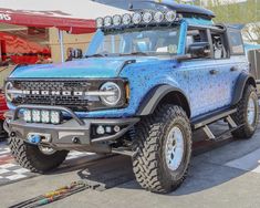 a large blue truck parked on top of a parking lot