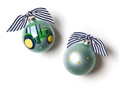 two christmas ornaments with tractors painted on them