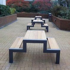 there are many benches on the brick walkway