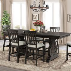 a dining room table with chairs and a chandelier