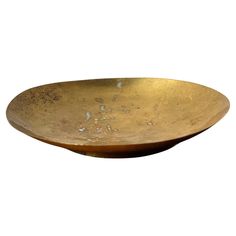 a large brass bowl on a white background