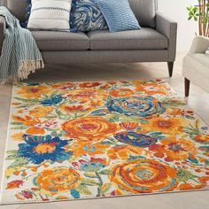 an orange and blue floral rug in a living room