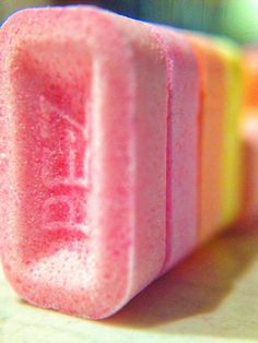 a close up view of some pink and yellow lollipops on a table