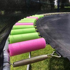 there are many pink and green roller coasters on the trampoline