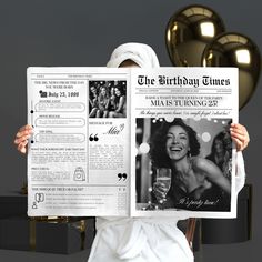 a woman in a white robe holding up a newspaper with an image of a woman on it