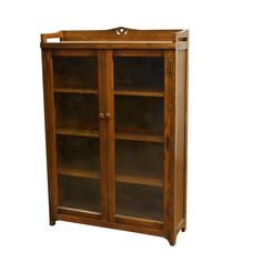 a wooden bookcase with glass doors on the front