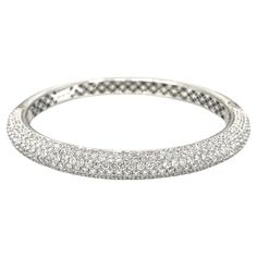 Diamond Pave Oval Bangle Bracelet in 18K White Gold Fine Quality Oval Shaped Diamond Pave Bangle Bracelet features 7 Rows of Round Brilliant Diamonds Pave set on the top half of the Bangle set in highly polished 18k White Gold. Bracelet is secured by an easy twisted hinged opening. Total diamond weight is 8.28 carats. Bracelet measures 0.25 inch wide and fits up to a 6.75 inch wrist. Bracelet weighs 31.1 grams. Bracelet is new without tags. Set in 18k White Gold. Hallmarks 18K 750 8.28 BUY WITH Gold Hallmarks, Oval Bangle, Modern Bangle, Pave Bangle, White Gold Bangle, Pave Bracelet, Bracelet Tennis, Modern Bracelets, Wrist Bracelet