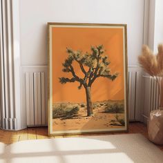 a framed photograph of a joshua tree in the desert