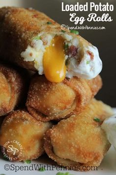 fried potato egg rolls stacked on top of each other with mayonnaise and sour cream