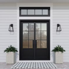 a black and white checkered door with two planters