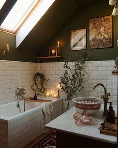 a bath room with a tub a sink and candles