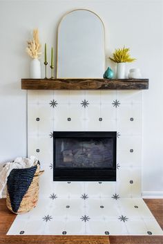 a fireplace with a mirror above it and other decorations on top of the mantel