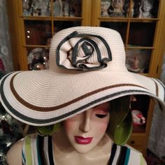 A Pretty D&Y Large Floppy Summer Hat. New With Tags. This Hat Has A Flower On The Side Made Out Of The Same Material As The Hat. Hat Is An Off White Or Cream. There Is A Pretty Shad Of Green And Brown Along Time As Well As In The Flower. Tag States Upf50+. Packable As Can Be Rolled Up. Content Is 100 Percent Paper. Spot Clean. Extremely Comfortable. Purchased About 6-7 Years Ago. Never Wore. Stored In A Hat Box. Non Smoking Household. Retro Brimmed Sun Hat For Vacation, Retro Wide Brim Sun Hat For Summer, Retro Wide Brim Sun Hat For Vacation, Adjustable Lined Sun Hat For Spring, Spring Adjustable Lined Sun Hat, Retro Wide Brim Hat For Vacation, Retro Fedora Straw Hat For Beach, Flower Shaped Sun Hat For Spring Vacation, Kentucky Derby Floral Hats