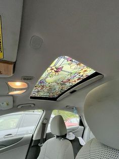 the interior of a car with a stained glass skylight in the back seat and sunroof