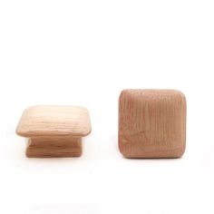 two wooden knobs sitting next to each other on a white surface