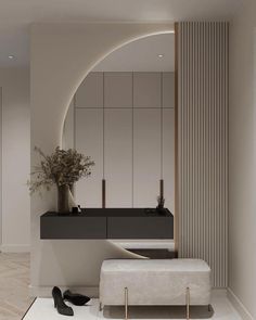 a modern bathroom with an oval mirror and white tile flooring, along with a bench that has a plant on it