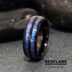 a wedding ring with blue and black wood inlays