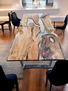 a dining table made out of wood with chairs around it and a window in the background