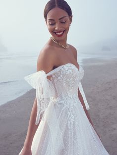 a woman in a white dress on the beach