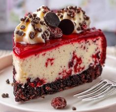 a piece of cheesecake with oreo cookies and cream on top sits on a plate