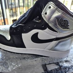 Metallic Blk And Whit Og Jordan 1 High-Top. Silver Lace-up Sneakers With Metallic Logo, Silver Sneakers With Metallic Logo For Streetwear, Silver Leather Low-top Custom Sneakers, Silver Custom Sneakers For Sports With Round Toe, Silver Custom Sneakers With Round Toe For Sports, Silver Custom Sneakers For Streetwear, Silver Custom Sneakers With Boost Midsole, Silver Custom Sneakers With Boost Midsole For Sports, Silver Custom Sneakers With Boost Midsole For Streetwear