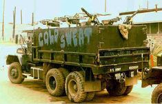 an army truck parked in front of a building