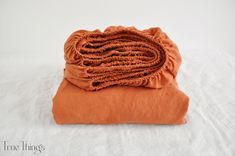 an orange blanket folded on top of each other