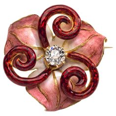 This beautiful jewel in the shape of a stylized lily is a fine example of the Art Nouveau art of enamelling. The flower stems are executed in translucent guilloché enamel. The flower petals are painted with opaque enamel in subtle shades of pink, rose and white. The veins of the flower leaves are highlighted in gold. The centre of the flower is set with a diamond. On the reverse the jewel is decorated with flower leaves, an understated sign of great quality. The brooch is signed on the pin CHIDO Elegant Flower Enamel Pin Collectible, Formal Flower-shaped Enamel Brooches, Formal Flower Enamel Brooches, Elegant Enamel Flower Brooches, Art Nouveau Pendant, Art Nouveau Art, Flower Stems, Flower Leaves, Nouveau Art