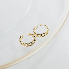 Add a touch of elegance to your outfit with our Libby Earrings. Featuring stunning chain link hoops plated with 18k gold, these earrings will elevate any look. Perfect for any occasion, these earrings will make you stand out in style. Get yours today and feel the luxury! *Also available in SILVER PRODUCT DETAILS Closure: Post Diameter: 1" Width: 1/2" Metal: 18k Gold Plated Brass Yellow Gold Hoop Earrings With Gold Chain For Gift, Gift Yellow Gold Hoop Earrings With Gold Chain, Gift Yellow Gold Hoop Earrings, Gold Hoop Earrings With Cable Chain For Gift, Gold Plated Hoop Earrings With Adjustable Chain As Gift, Gold Plated Hoop Earrings With Adjustable Chain, Dainty Gold-plated Hoop Earrings With Adjustable Chain, Gold Chain Link Earrings Tarnish Resistant, Tarnish Resistant Gold Plated Link Earrings